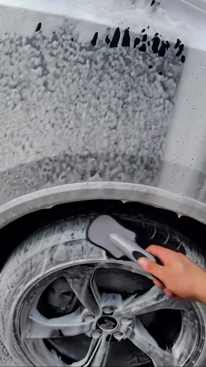 Vehicle wheel being brushed during the detail